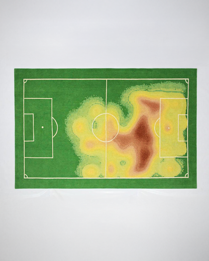 One of one football heat map rug shown flat from above in green yellow and red